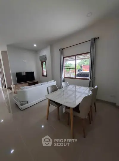 Modern living room with dining area and large window view