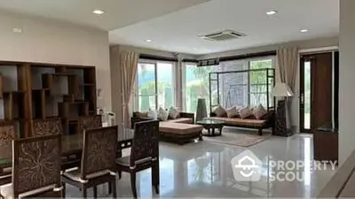 Spacious living room with modern furniture and large windows offering natural light.