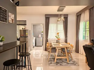 Modern open-plan kitchen and dining area with stylish decor and natural light.