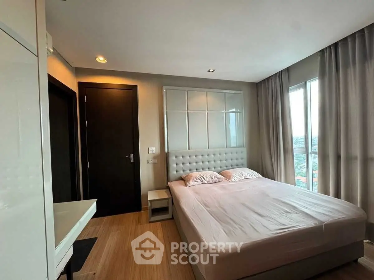 Modern bedroom with large window and elegant decor