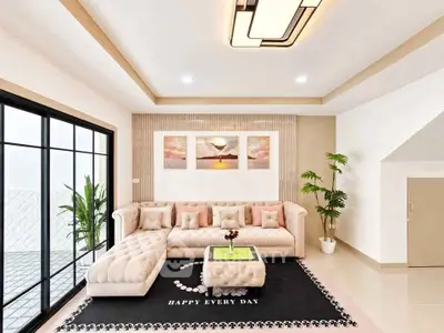 Elegant living room with plush sectional sofa, modern decor, and large windows for natural light.