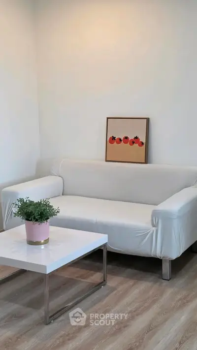 Modern living room with white sofa, stylish coffee table, and minimalist decor.