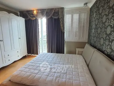 Elegant bedroom with luxurious drapes and stylish wallpaper, featuring a cozy bed and classic wardrobe.