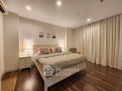 Spacious and elegant bedroom with cozy lighting and modern decor