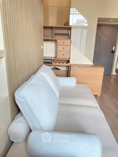 Modern living room with cozy white sofa and stylish wooden furniture