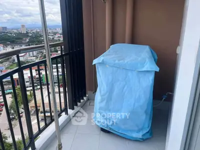 High-rise balcony with covered washing machine and city view
