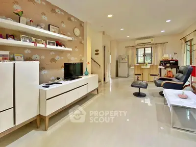 Spacious living room with modern decor and open layout, featuring a TV unit and comfortable seating.