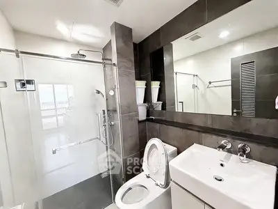 Modern bathroom with sleek design, glass shower, and contemporary fixtures.