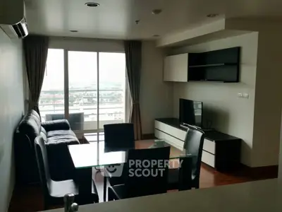 Modern living room with sleek furniture and city view from balcony, perfect for urban living.