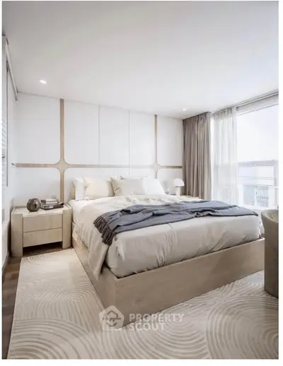 Luxurious modern bedroom with elegant decor and large windows offering natural light.