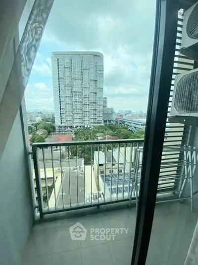 Stunning city view from a modern apartment balcony with sleek railing and expansive skyline.