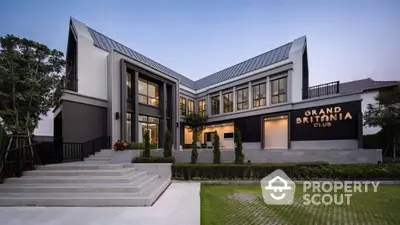 Modern architectural building with sleek design and lush greenery, perfect for upscale living.