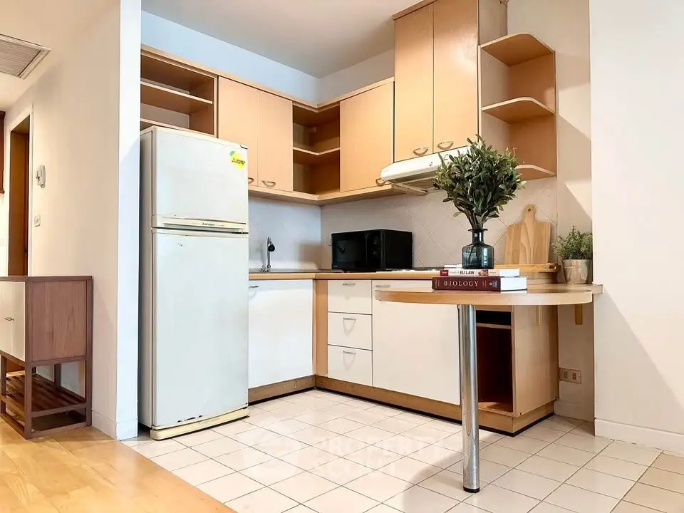 Charming kitchen with open layout, featuring modern appliances and stylish cabinetry, perfect for culinary enthusiasts.