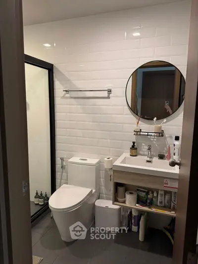 Modern bathroom with sleek fixtures and glass shower enclosure