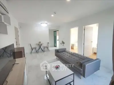 Spacious modern living room with sleek furniture and marble flooring