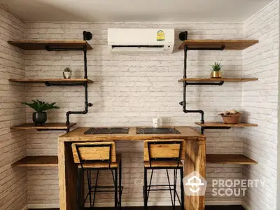 Charming rustic-style kitchenette with natural wood countertops, industrial pipe shelving, and exposed brick walls, perfect for cozy urban living.