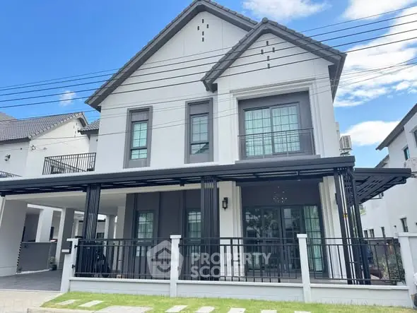 Elegant modern two-story house with large windows and stylish facade in a serene neighborhood.