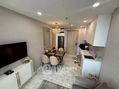 Modern open-layout living room with chic dining area and sleek kitchen design.