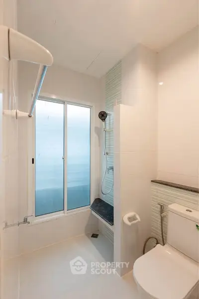 Modern bathroom with sleek shower and frosted window for privacy