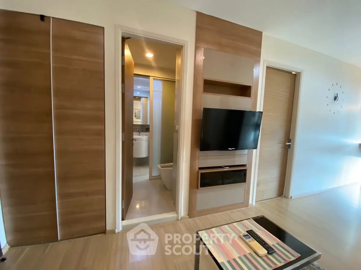 Modern living room with wooden accents and wall-mounted TV