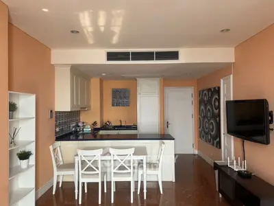 Charming open-layout kitchen with dining area and modern decor in a cozy apartment.