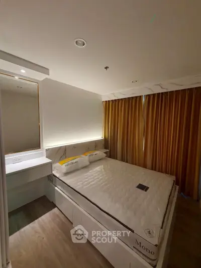 Modern bedroom with cozy lighting and elegant decor in a stylish apartment.