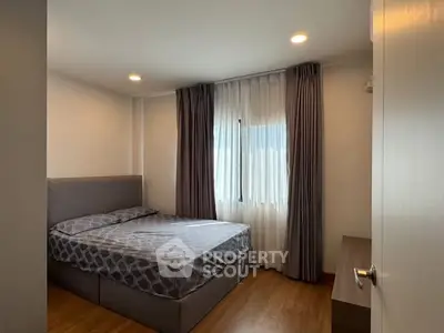 Cozy bedroom with modern decor and ample natural light