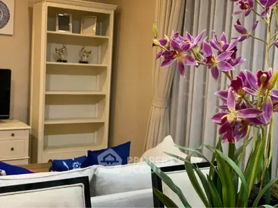 Charming living room with elegant decor and vibrant orchids enhancing the cozy ambiance.