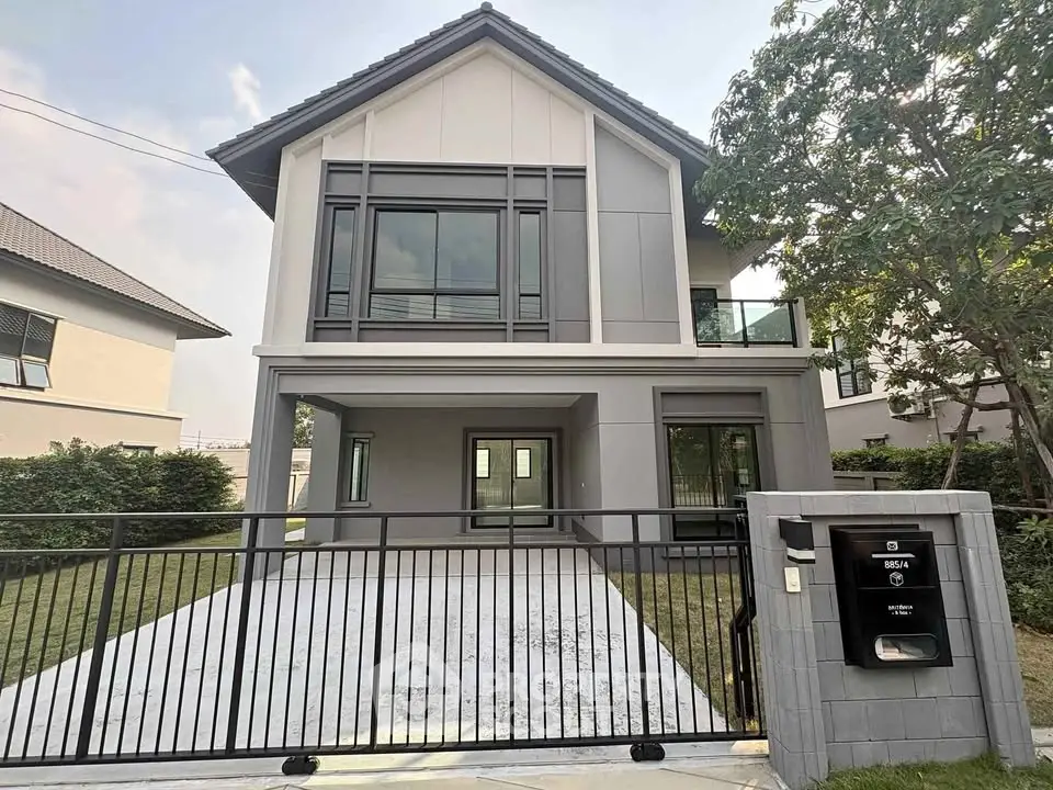 Modern two-story house with sleek design and spacious driveway in a serene neighborhood.