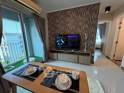 Modern living room with stylish decor and balcony view in a contemporary apartment.