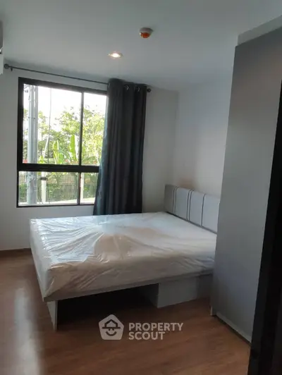 Modern bedroom with large window and natural light in a stylish apartment