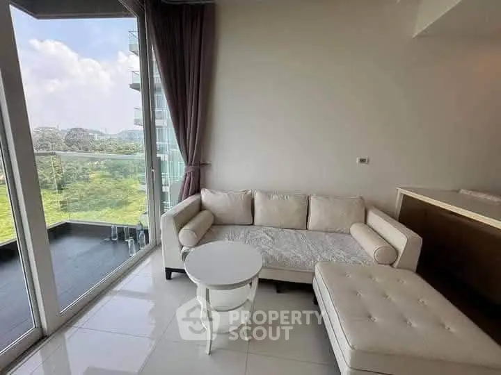 Modern living room with large windows and scenic view, featuring elegant white furniture and sleek design.