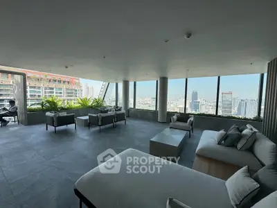 Spacious modern living room with panoramic city views and elegant furnishings.