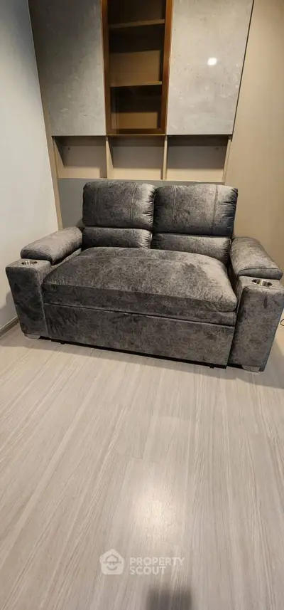 Modern gray sofa in stylish living room with sleek flooring
