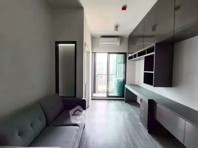 Modern living room with sleek cabinetry and balcony view in urban apartment