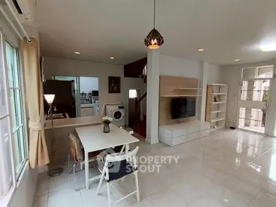 Spacious modern living room with dining area and stylish lighting