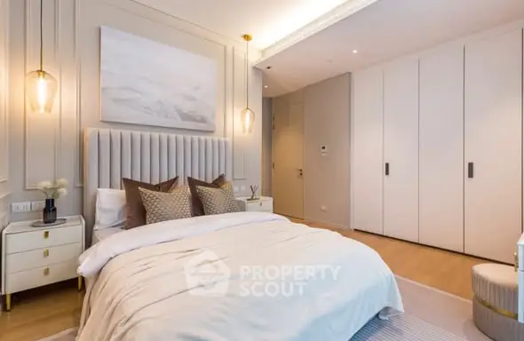 Luxurious modern bedroom with elegant decor and ample storage space.