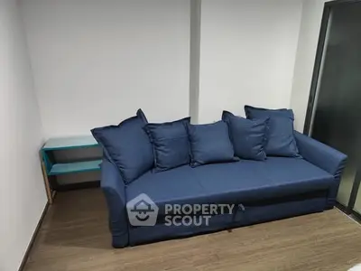 Modern living room with stylish blue sofa and minimalist decor