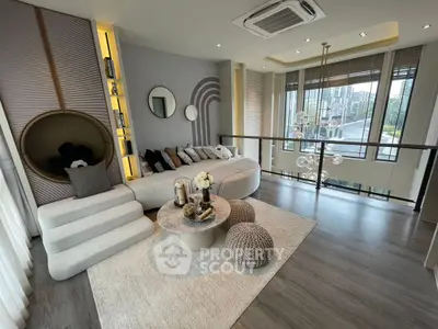 Modern living room with stylish decor and large windows offering a scenic view.