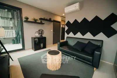 Modern living room with sleek black sofa and stylish decor