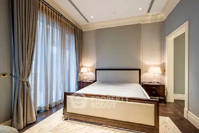 Luxurious bedroom with elegant decor and large windows in a modern apartment.