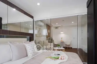 Modern bedroom with glass partition and cozy living area