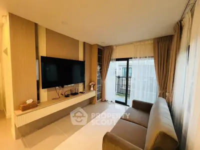 Modern living room with large TV and balcony access in stylish apartment