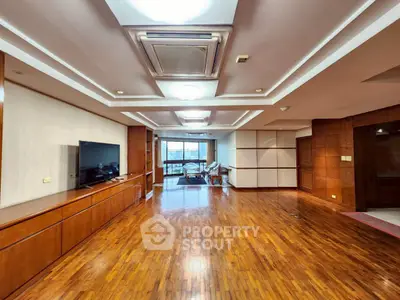 Spacious living room with wooden flooring and modern ceiling design