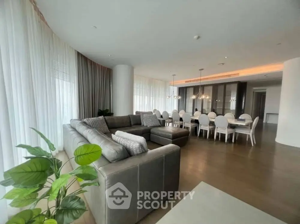 Luxurious open-plan living and dining area with elegant furnishings and natural light