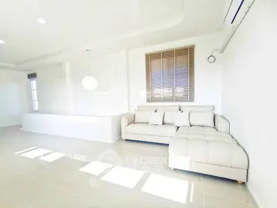Bright and spacious living room with modern white sofa and natural light