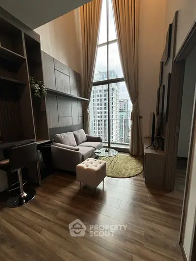 Luxurious high-ceiling living room with modern decor and stunning city view.
