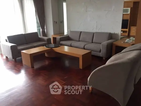 Spacious living room with modern furniture and wooden flooring