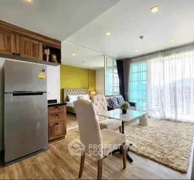 Spacious open-plan living room with modern kitchen and large windows