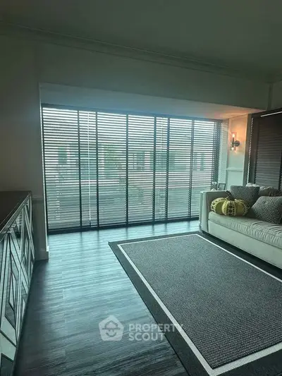 Spacious living room with floor-to-ceiling windows and modern decor